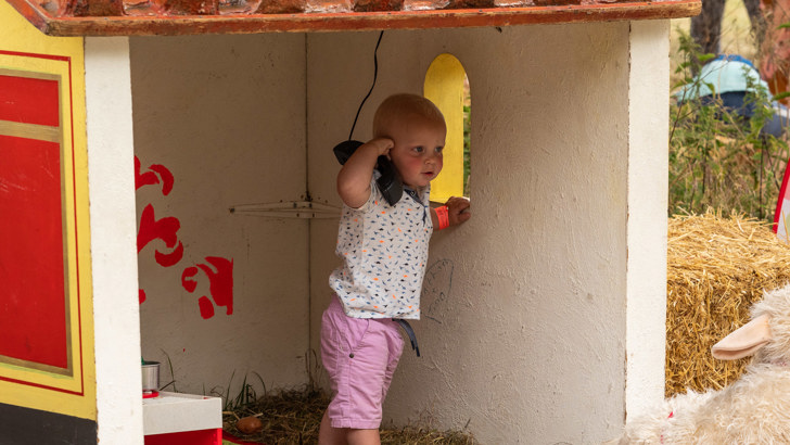 Small child playing with toy phone