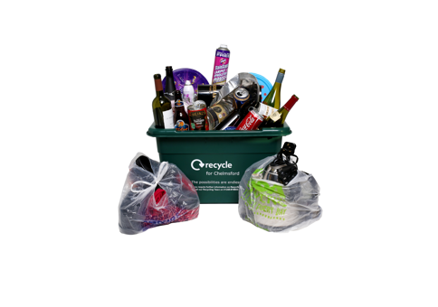 Green crate full of items to be recycled, such as glass bottles and tin cans