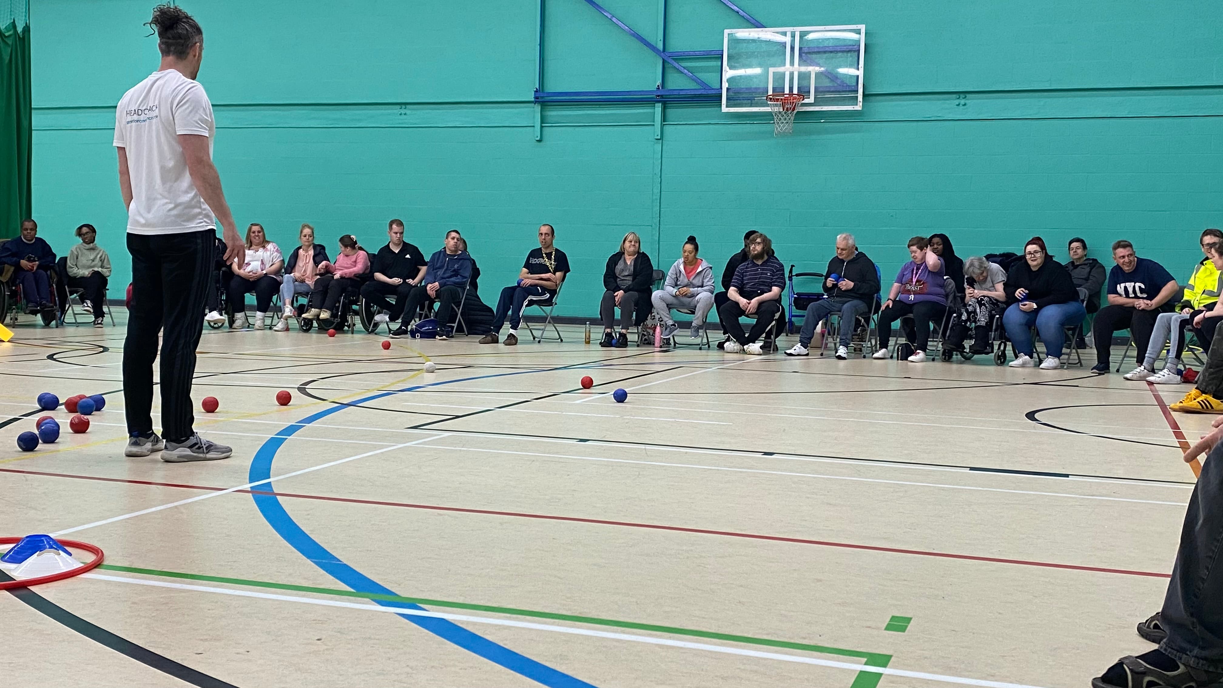 A group of people listening to the rules of bocci