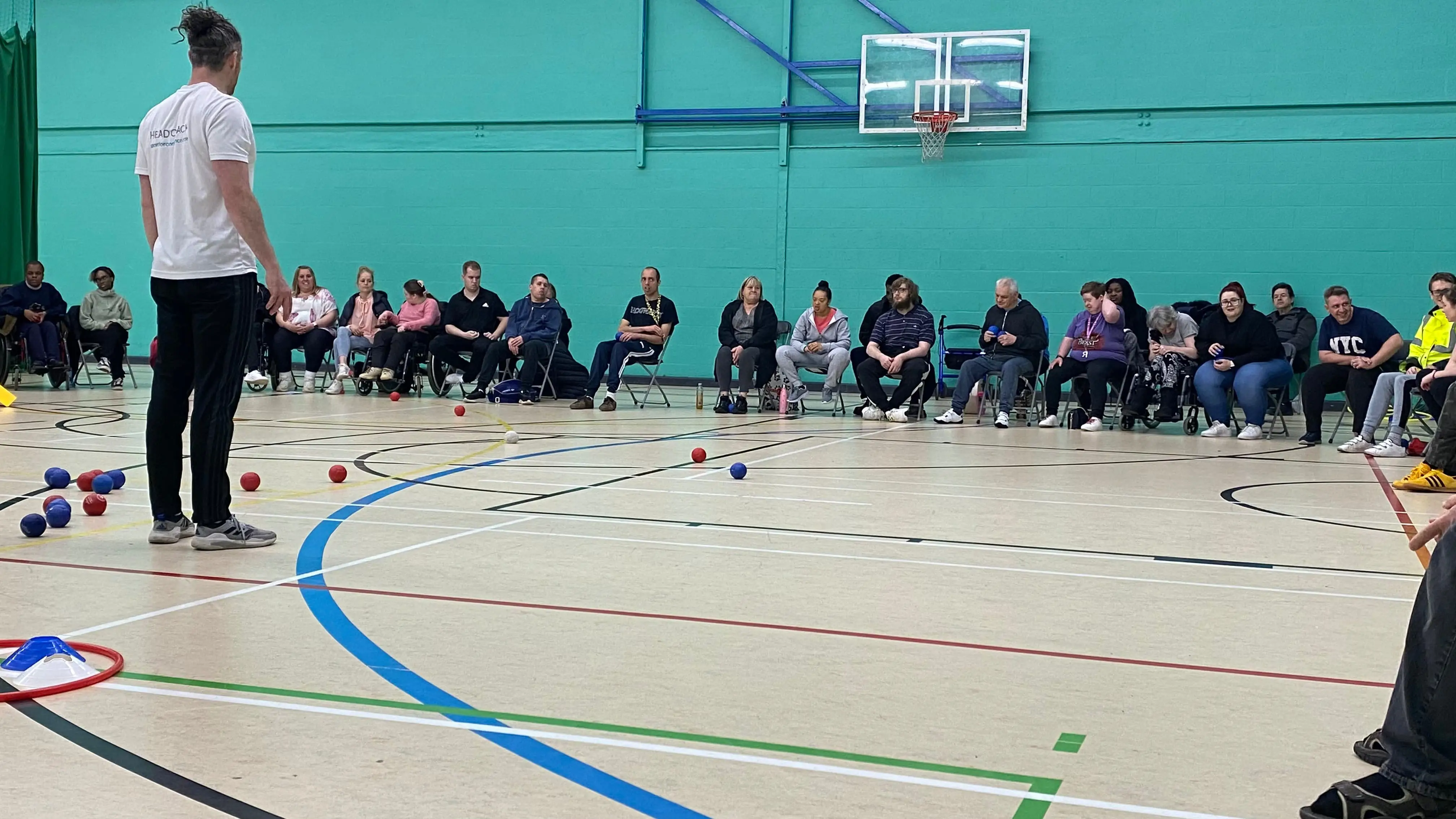 A group of people listening to the rules of bocci