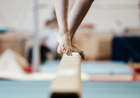 Gymnast balancing on the beam
