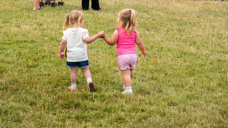 Two small girls holding hands