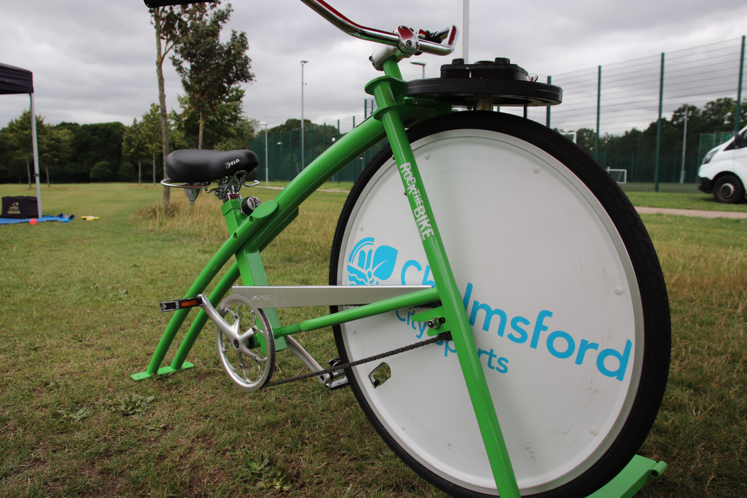 Large static bike gren with green frame and mechanism on top to drive a smoothie maker