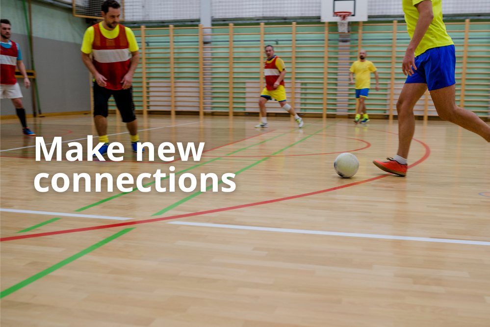 Make new connections. Men playing indoor football.