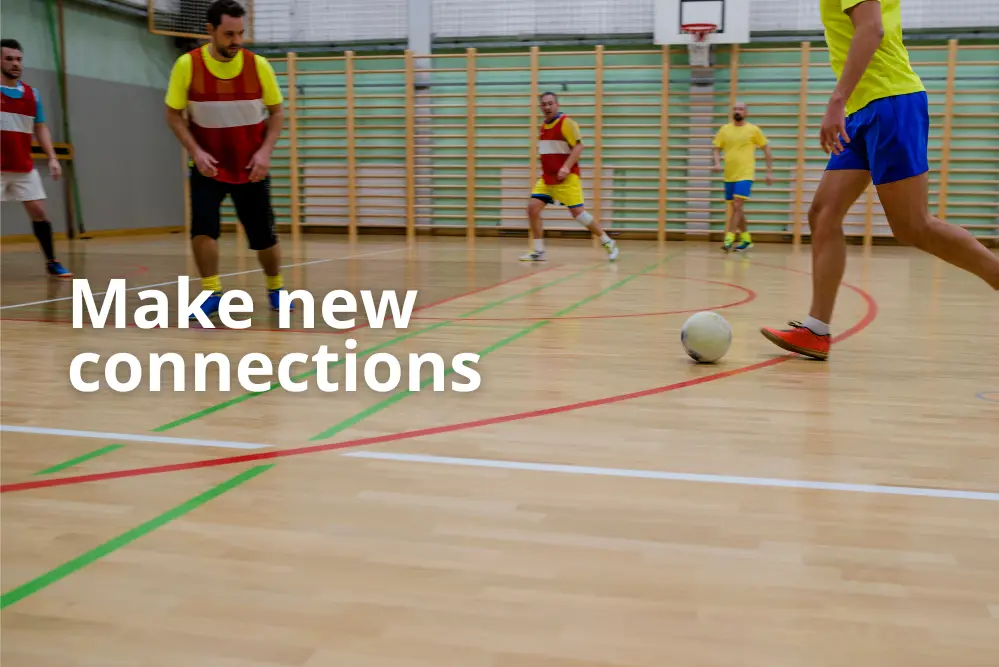 Make new connections. Men playing indoor football.