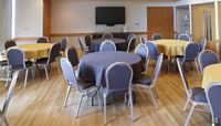 The Wells Suite set up with round tables.  preview