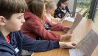 The kids at Radio Club look over their scripts.  preview