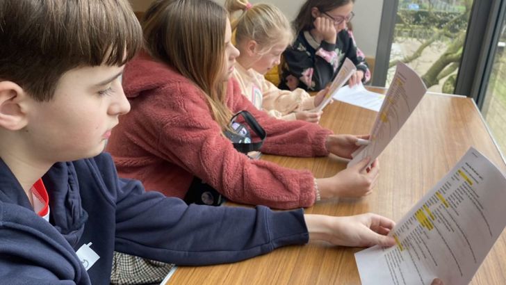 The kids at Radio Club look over their scripts. 