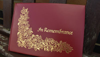 Red leather book with gold decoration and 'In Remembrance' lettering preview