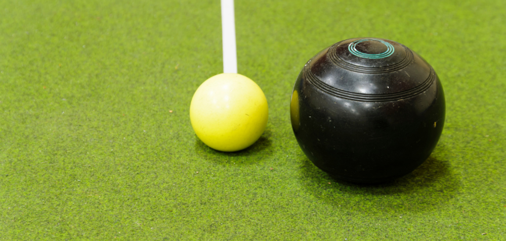 Bowls balls on an indoor green astroturf.