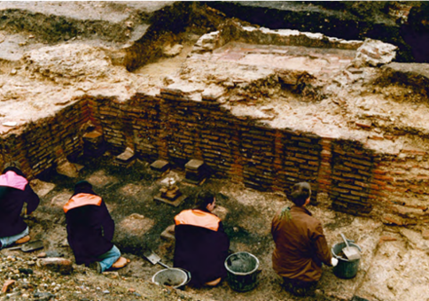 Archaeologists uncovering the heating system of the Roman baths