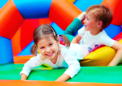 Girl and boy playing on soft play