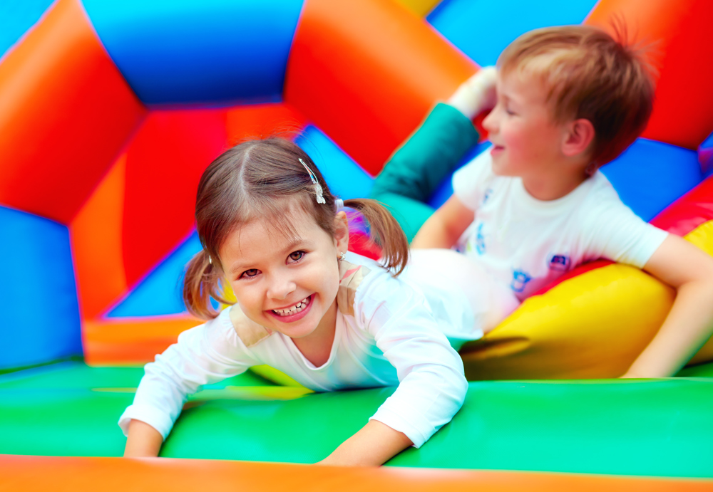 Girl and boy playing on soft play