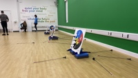 Plastic arrows stuck to an Archery target, part of an indoor archery session in a fitness studio preview