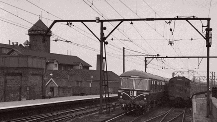 Chelmsford railway station, showing trains on tracks with mill and water tower behind  (Photograph courtesy and copyright © Stuart Axe)
