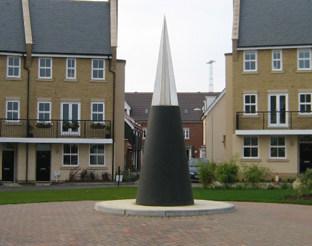 Large black cone with steel tip in a square in a residential area