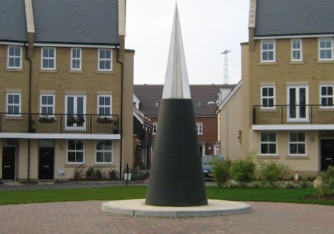 Large black cone with steel tip in a square in a residential area