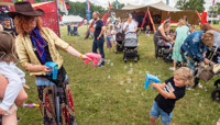 Small boy having fun firing a bubble gun preview