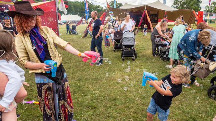 Small boy having fun firing a bubble gun