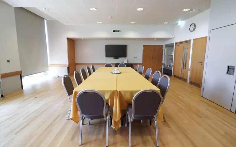 The Wells Suite set up with one large rectangular table.
