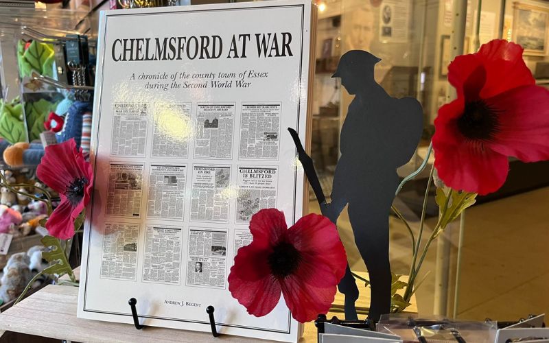 Chelmsford at War book on display in the museum gift shop. It's surrounded by red poppies. 