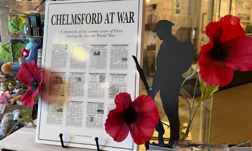 Chelmsford at War book on display in the museum gift shop. It's surrounded by red poppies. 