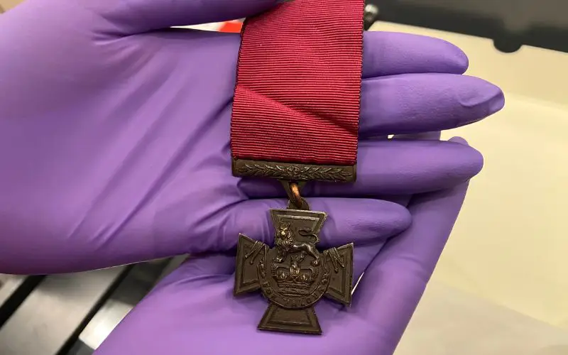 A close up of the front of a Victoria Cross medal. 