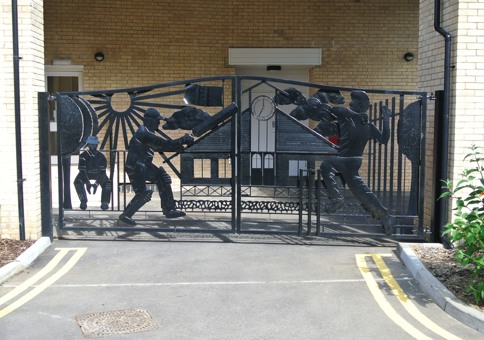 Wrought iron gates featuring cricketing figures