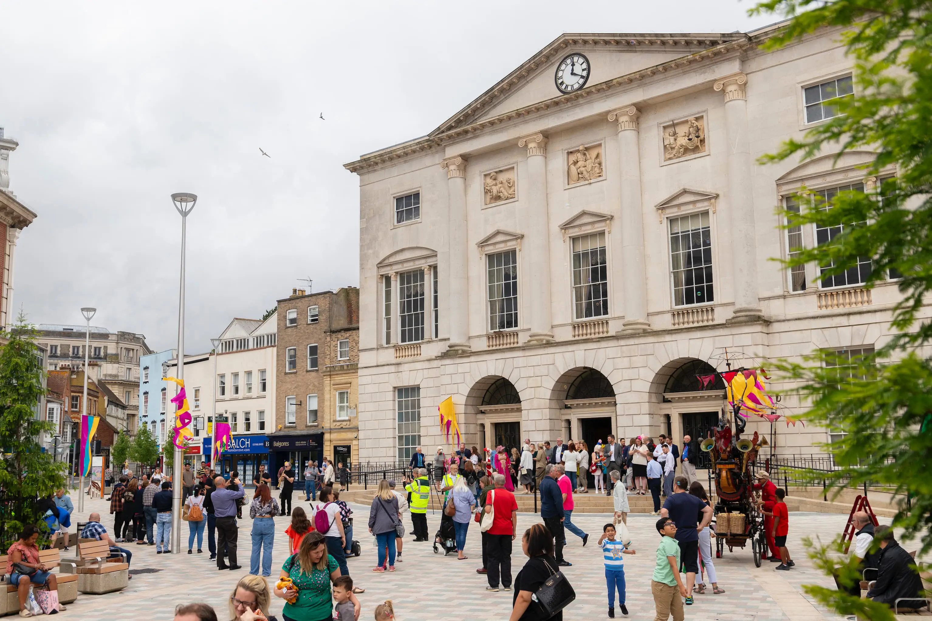 People mingling around in large public open space at top of Chelmsford High Street, outside Shire Hall