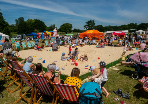 Families playing in large outdoor sandpit