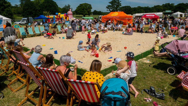 Families playing in large outdoor sandpit