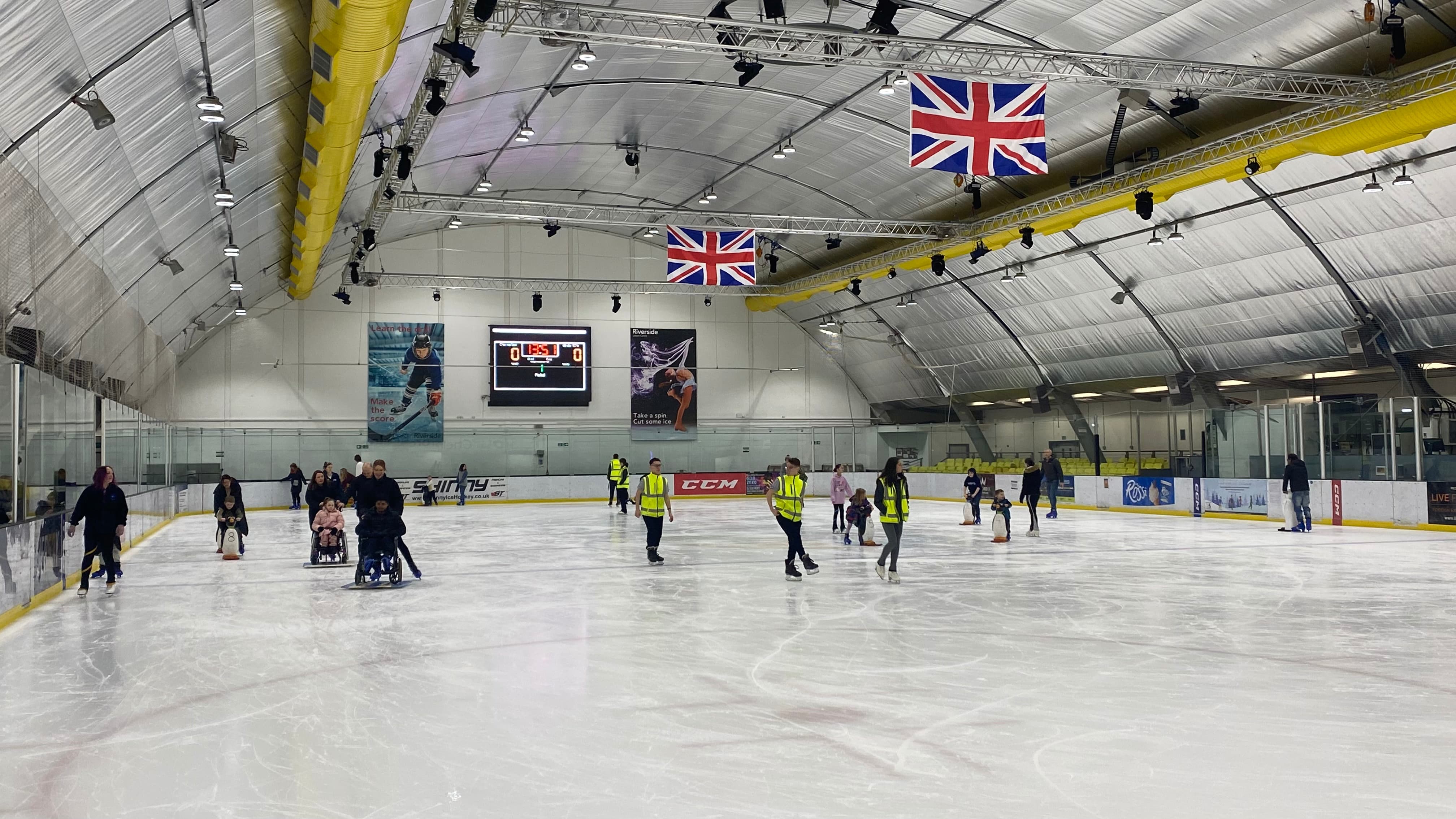 A group of people learning to ice skate