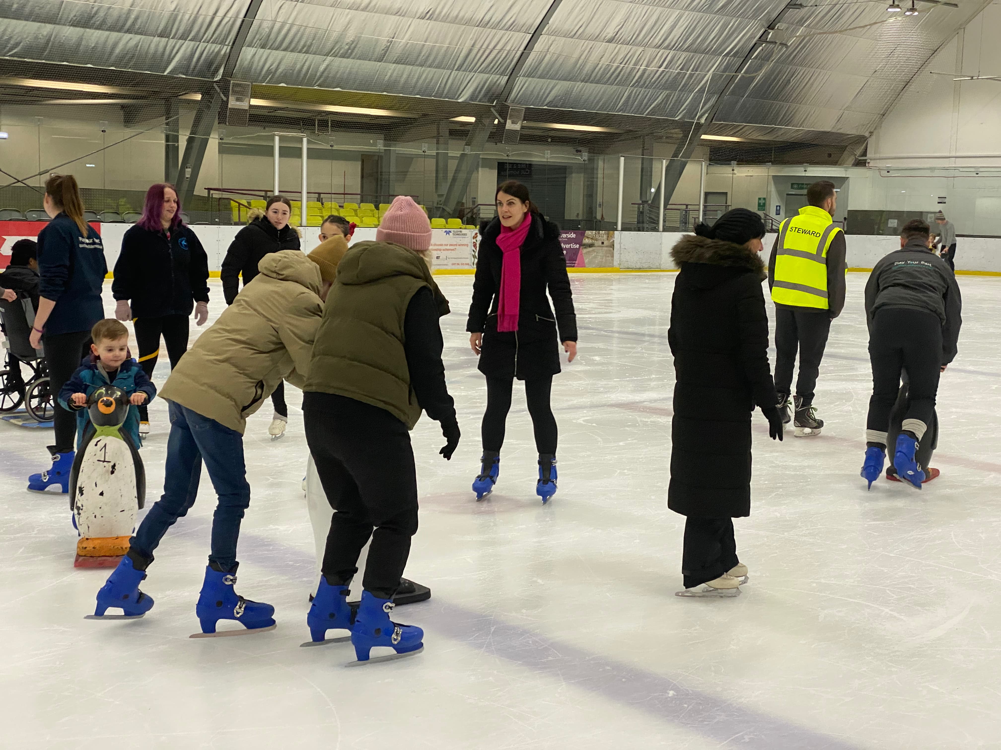Parents and children ice skating together