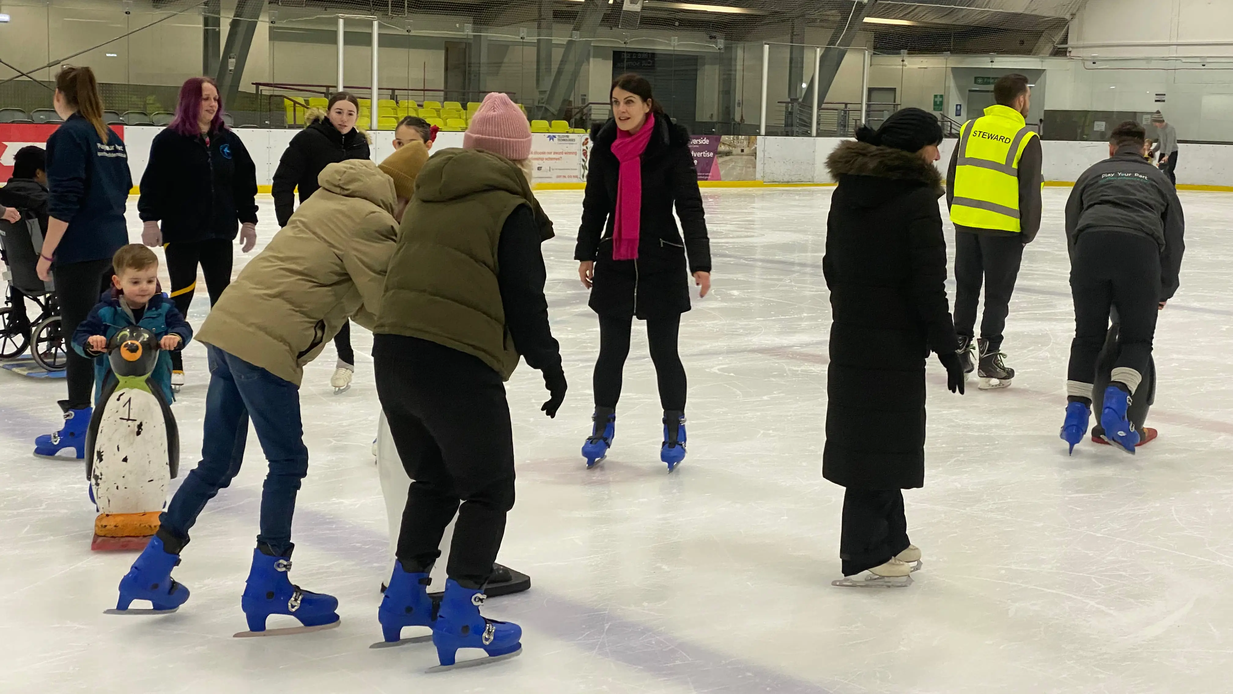 Parents and children ice skating together