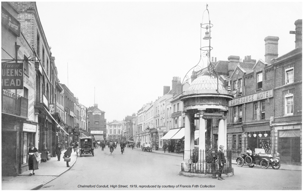 View of Chelmsford High Street from 1919 showing large stone conduit in road, looking up towards Shire Hall