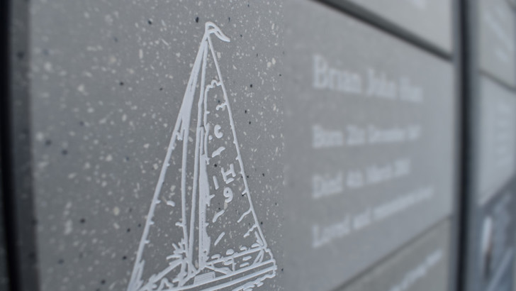 Small plaque with sailing ship etched into it