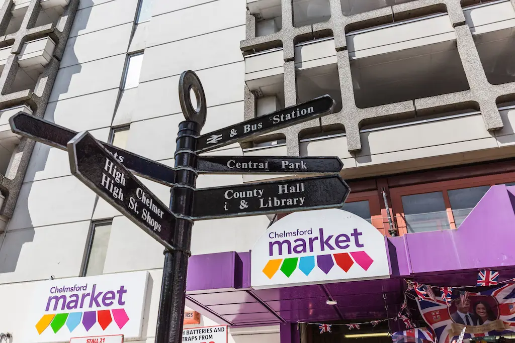 Black fingerpost sign outside Chelmsford Market