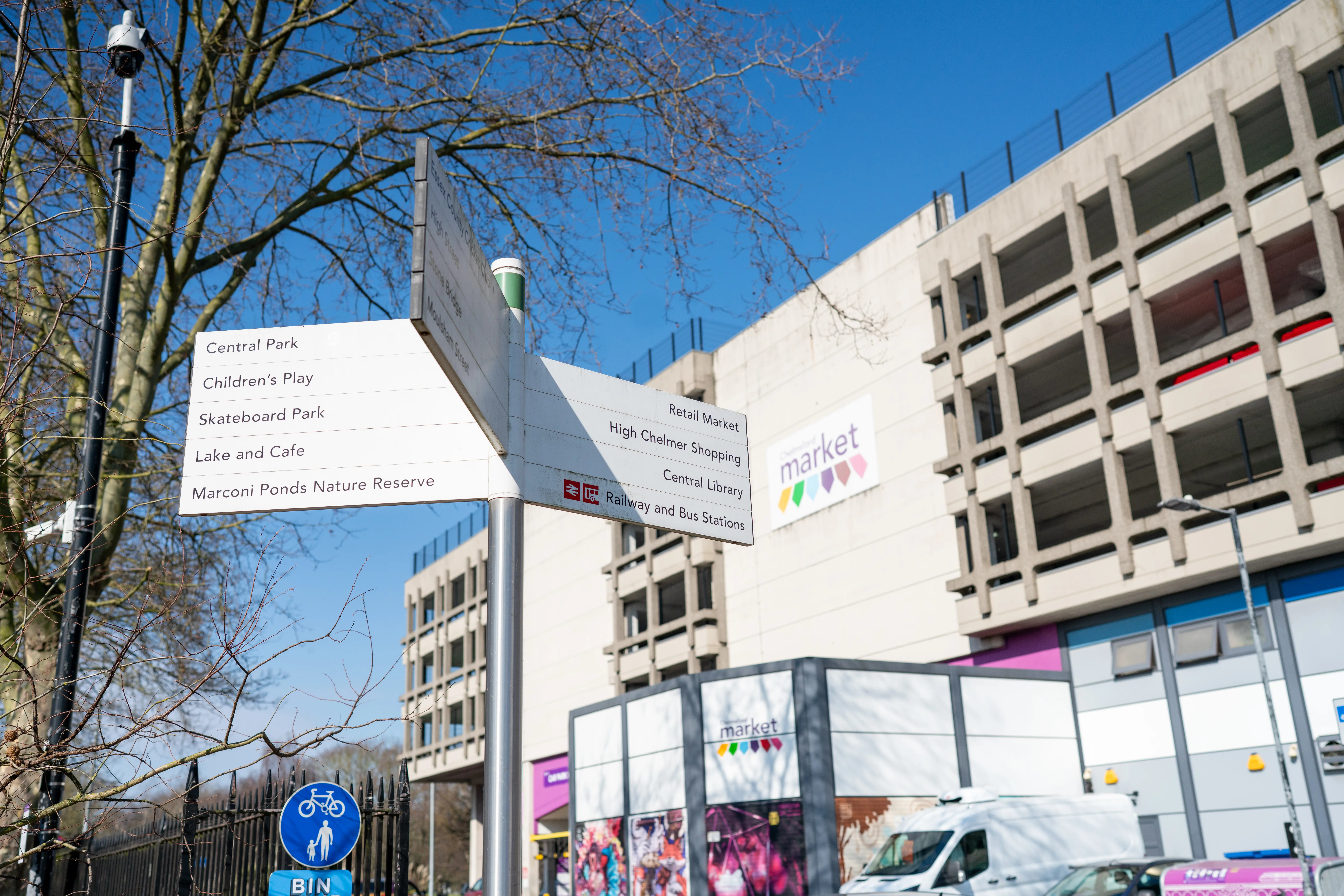 White wayfinding sign outside Chelmsford Market