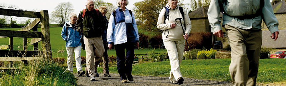 Group of older people walking in rural setting