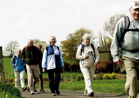 Group of older people walking in rural setting