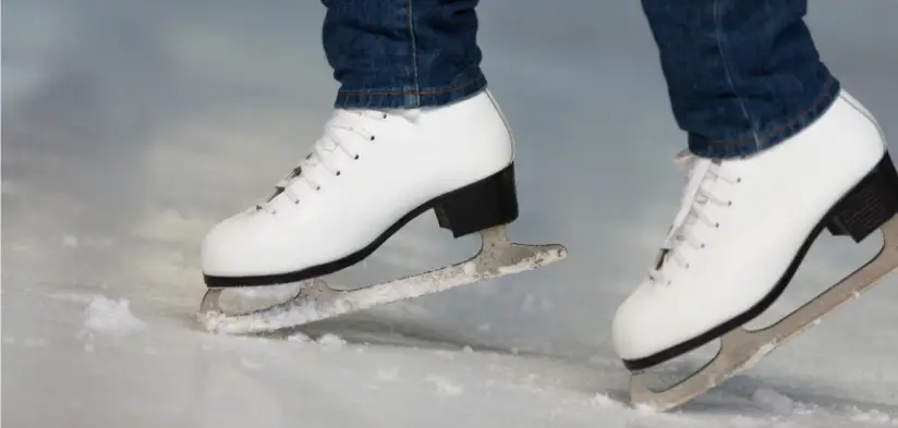 Woman wearing white ice skating boots