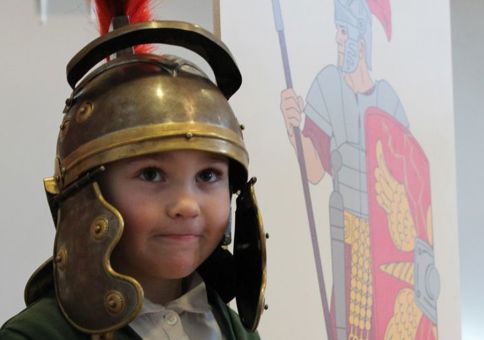 Young girl in a Roman helmet