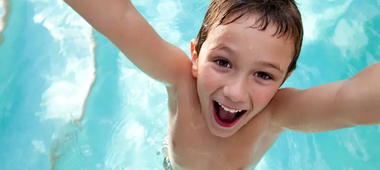 Excited-looking boy in a pool