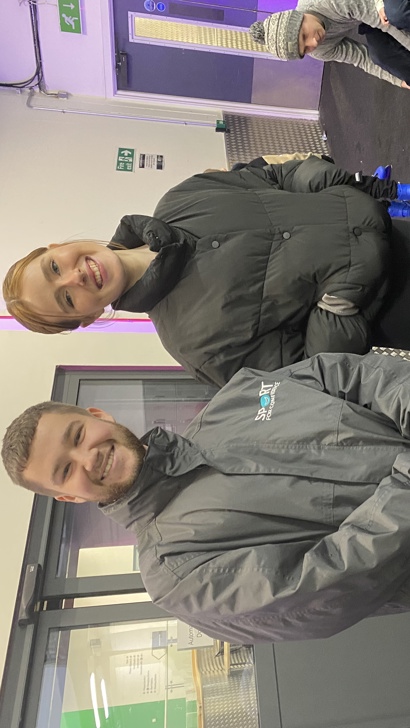 Two Sport for Confidence ice skating coaches stood side by side off-ice, smiling