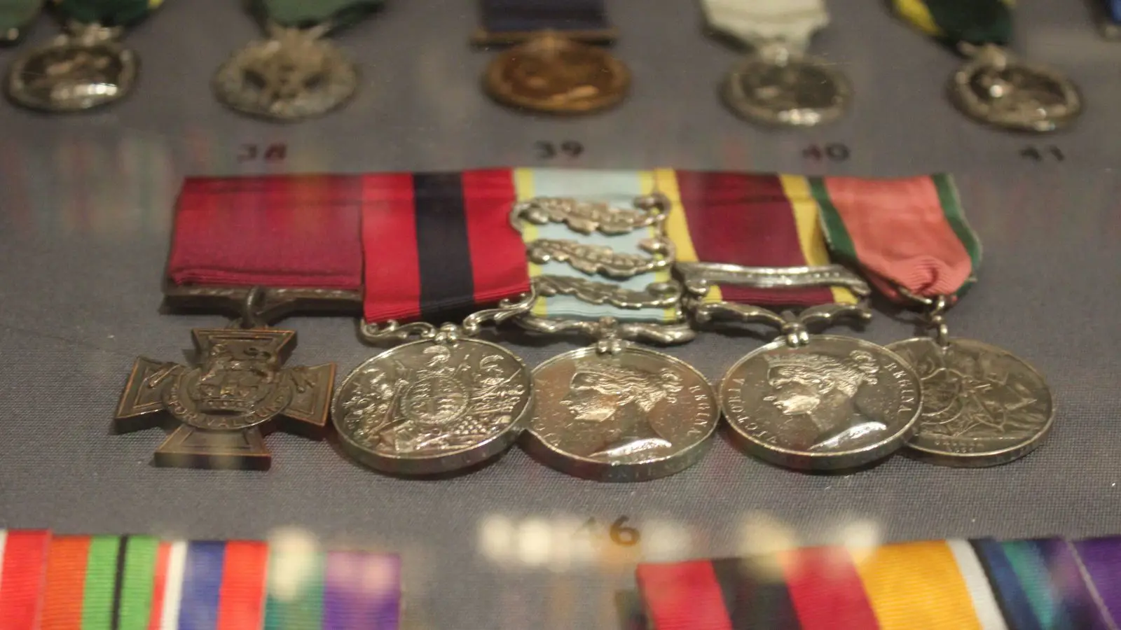 A close up of five medals on display.