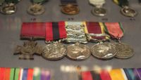 A close up of five medals on display.  preview