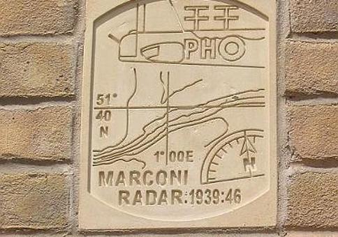 Stone plaque on a brick wall saying 'Marconi Radar: 1939:46'