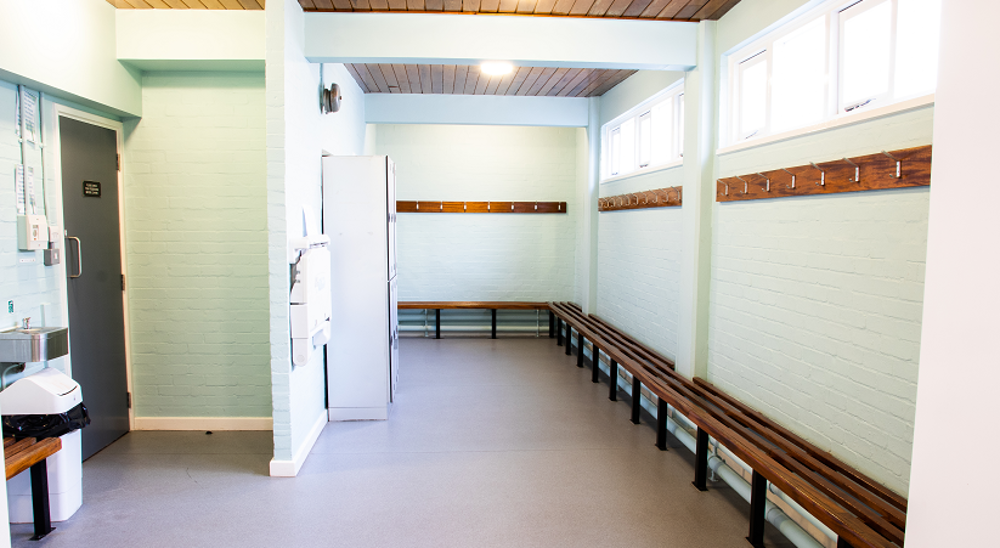 Changing room with benches running around the room