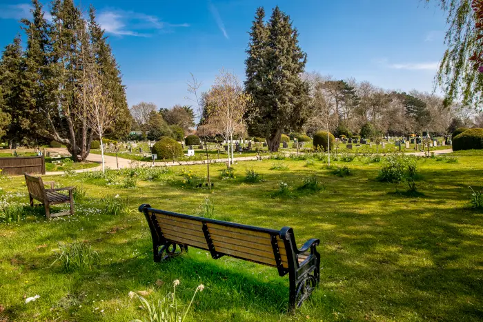 Benches scattered around the cemetery grounds