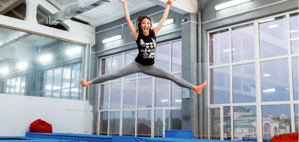 Woman in mid-air while jumping on a trampoline